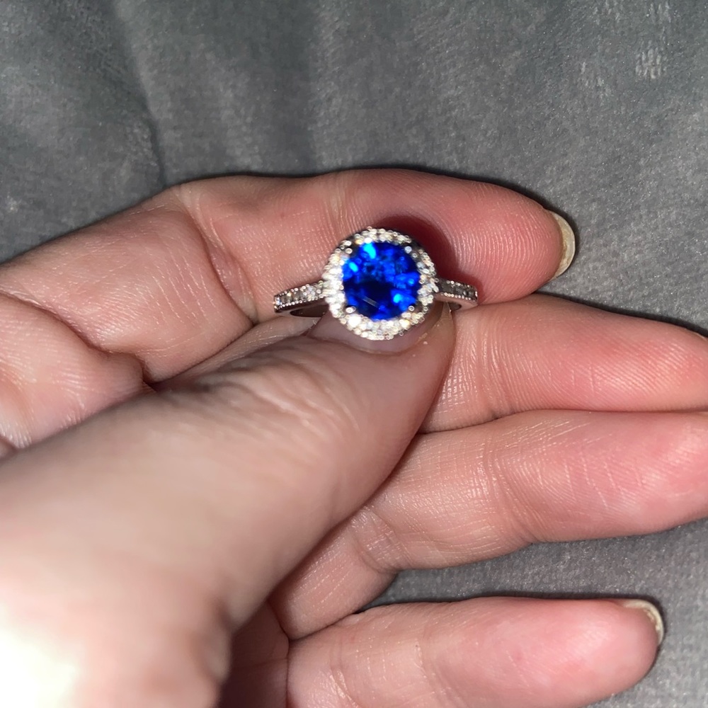 Ladies size 7 silver, cubic zirconia with halo setting and CZ’s along the sides